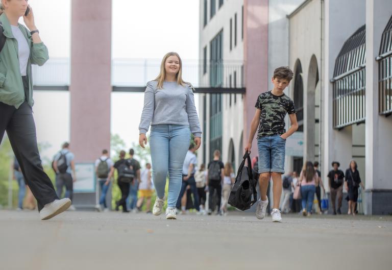 Meisje en jongen samen op druk plein